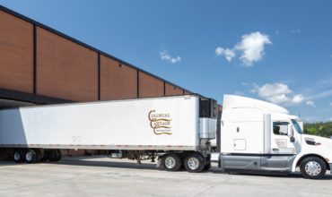 Colonial Cartage tractor trailer backed up to a dock door