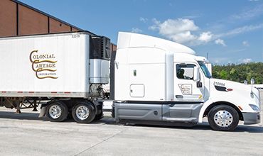 Colonial Cartage tractor trailer parked at a dock door