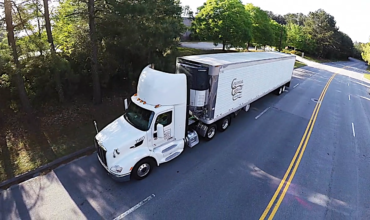 Colonial Cartage tractor trailer driving down the road providing plant support